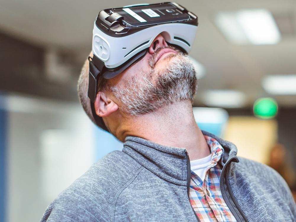 man looking up while wearing a 360-degree video headset